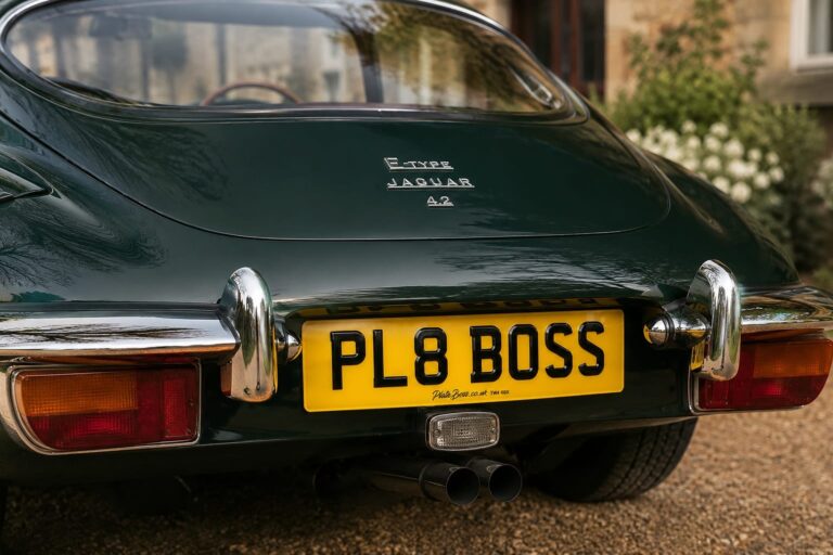 rear view of a british racing green jaguar e-type 4.2 with a personalised PL8 BOSS 3D gel number plate